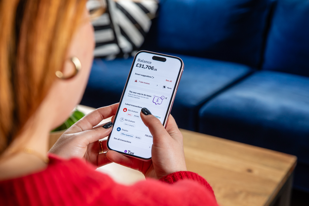 Woman small business owner using Countingup app on iPhone