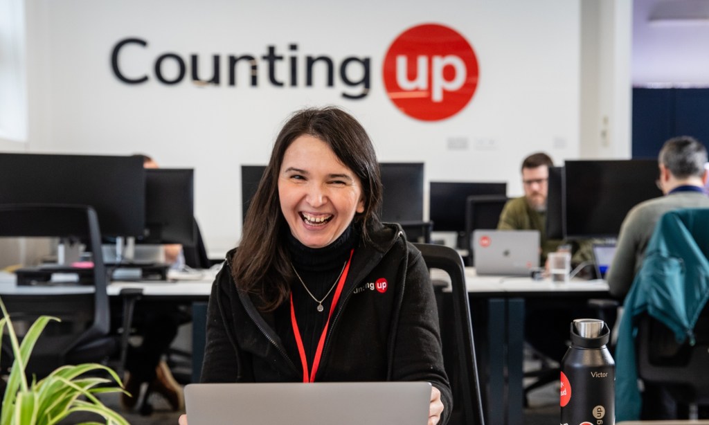 Countingup team with logo behind in office