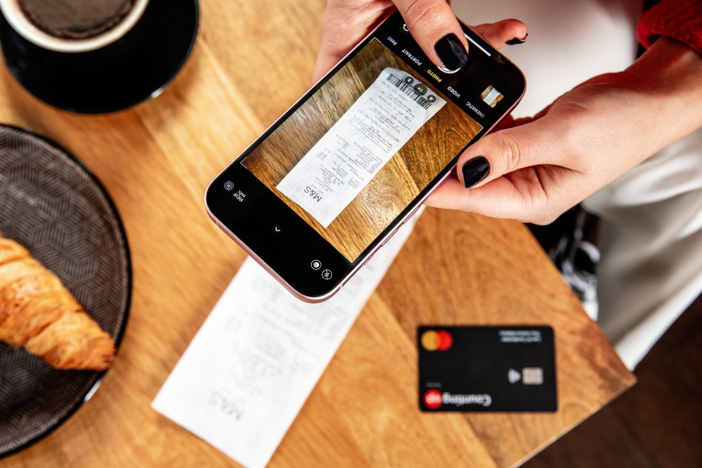 Lady taking photo of receipt with Countingup app